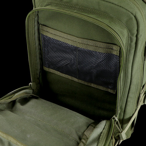 A close-up of the Condor Compact Assault Backpack 24L - Scorpion OCP reveals an empty main compartment and a mesh zippered pocket inside the front flap.